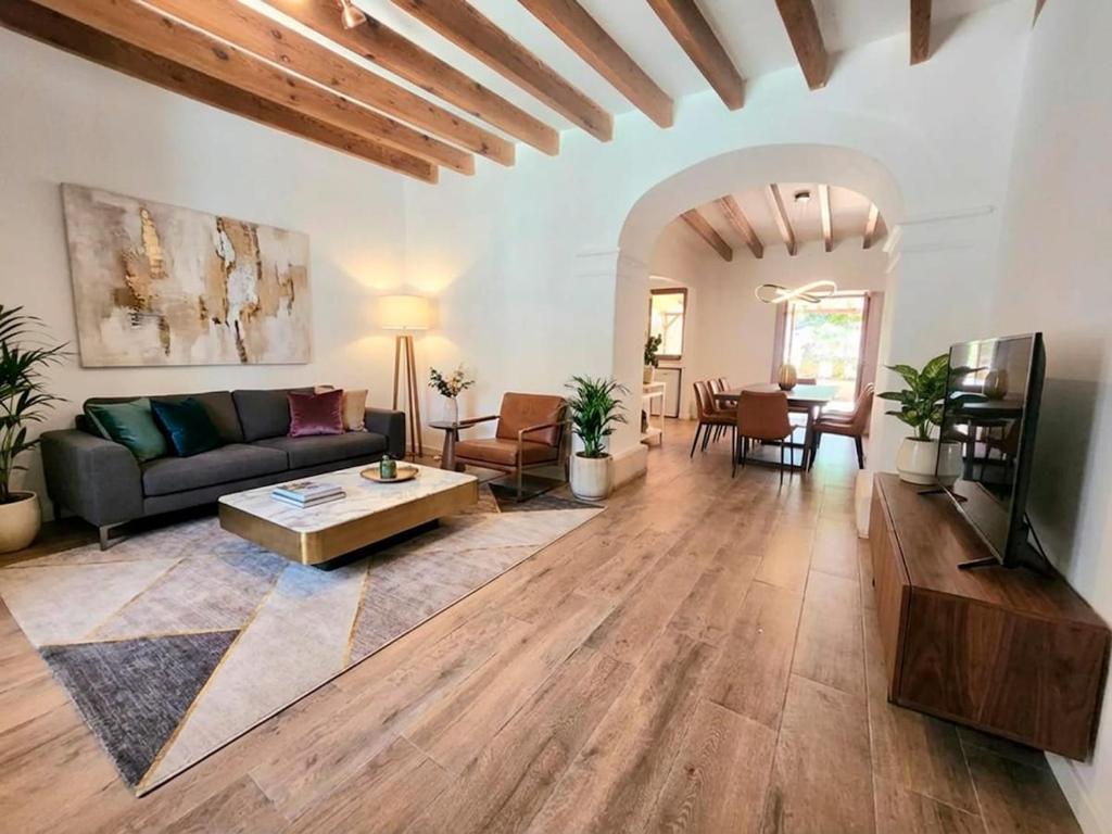 een woonkamer met een bank en een tafel bij Casa Ca'n Bernat in Santanyi