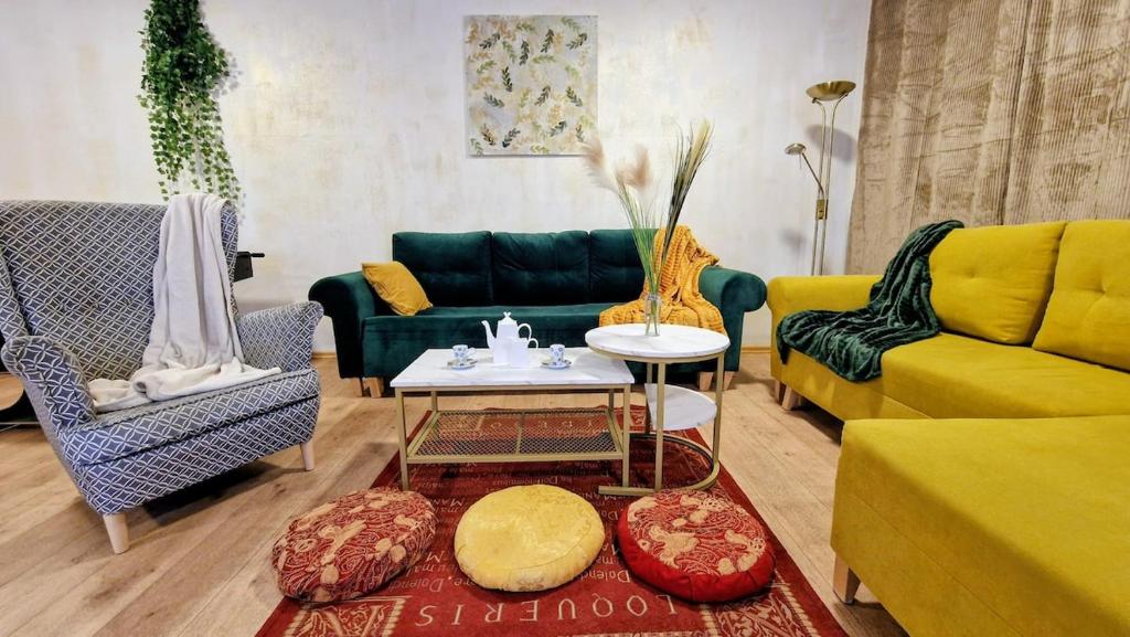 a living room with yellow and green furniture at Orientarium Atlas Arena Family House in Łódź