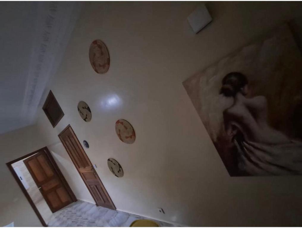 a room with clocks hanging on the wall at Superetoile in Rufisque