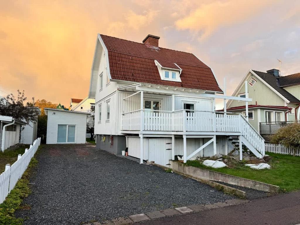 a white house with a red roof at Workers Big Villa - 5 BR - 2 Bath - 10 min to Volvo in Gothenburg