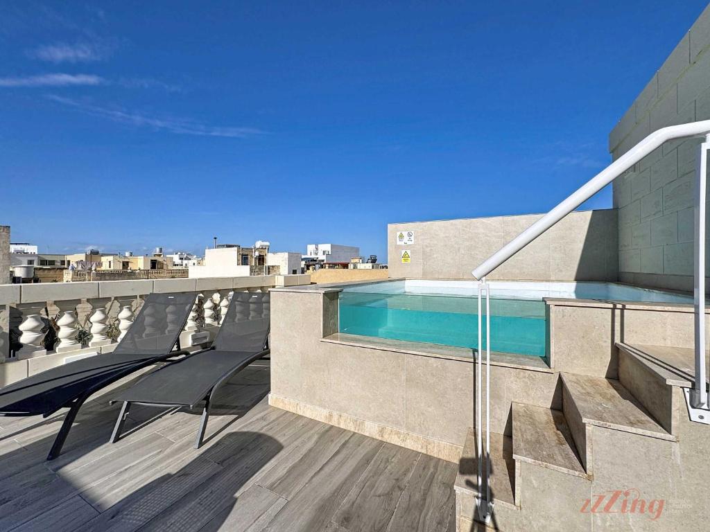 a swimming pool on the roof of a building at Malta Rooftop Villa with Private Plunge Pool & BBQ in Hal Ghaxiak