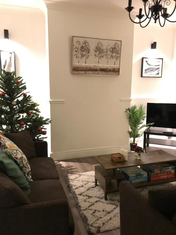 a living room with a christmas tree and a couch at Ushaw HillTop View in Ushaw Moor