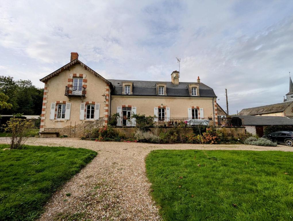 een groot huis met een oprit ervoor bij Chambre "Bleue", Le Priouzé in Chézelles