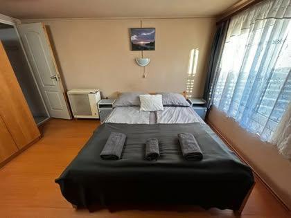 a bedroom with a bed with two remote controls on it at Boglárka Vendégház in Balatonboglár