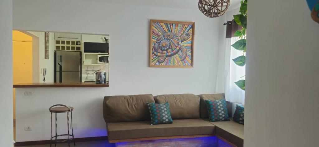 a living room with a couch and a kitchen at Home 013 in São Vicente