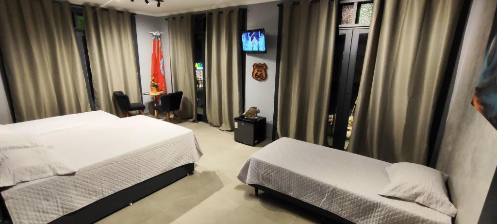 En eller flere senge i et værelse på Portal suítes Avenida Paraty