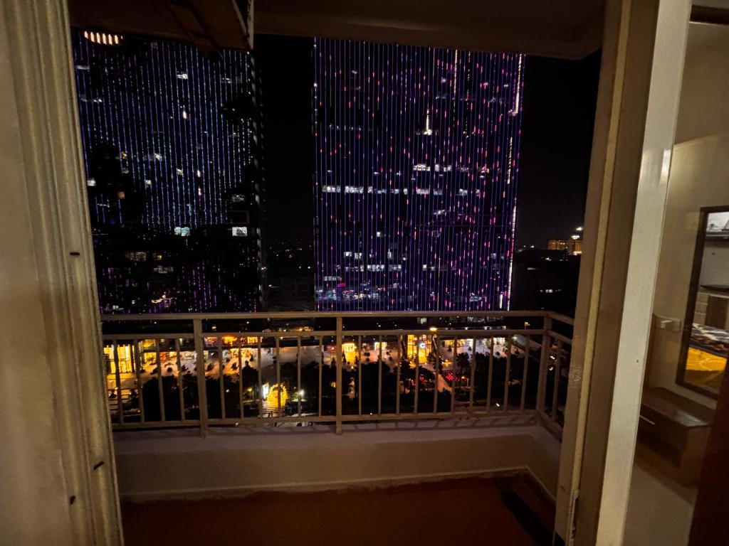 a view of a city at night from a balcony at The night view in Noida