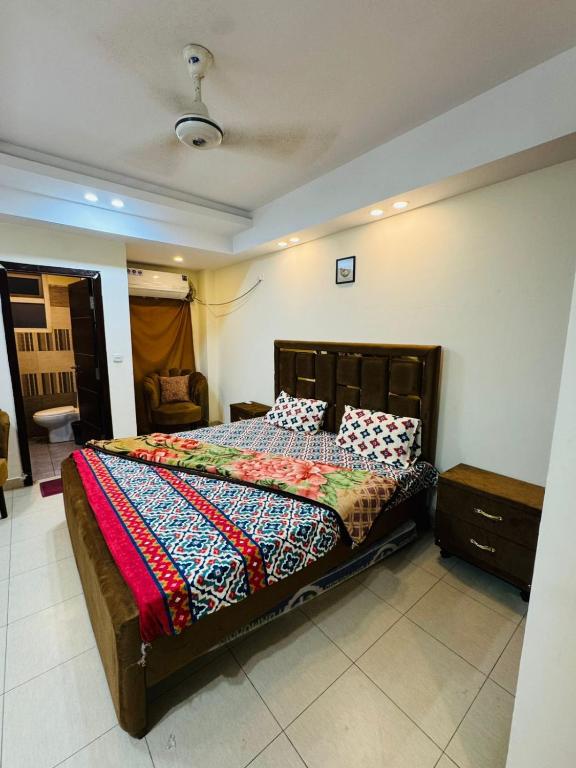 a bedroom with a large bed in a room at Syed Apartment 104 in Islamabad
