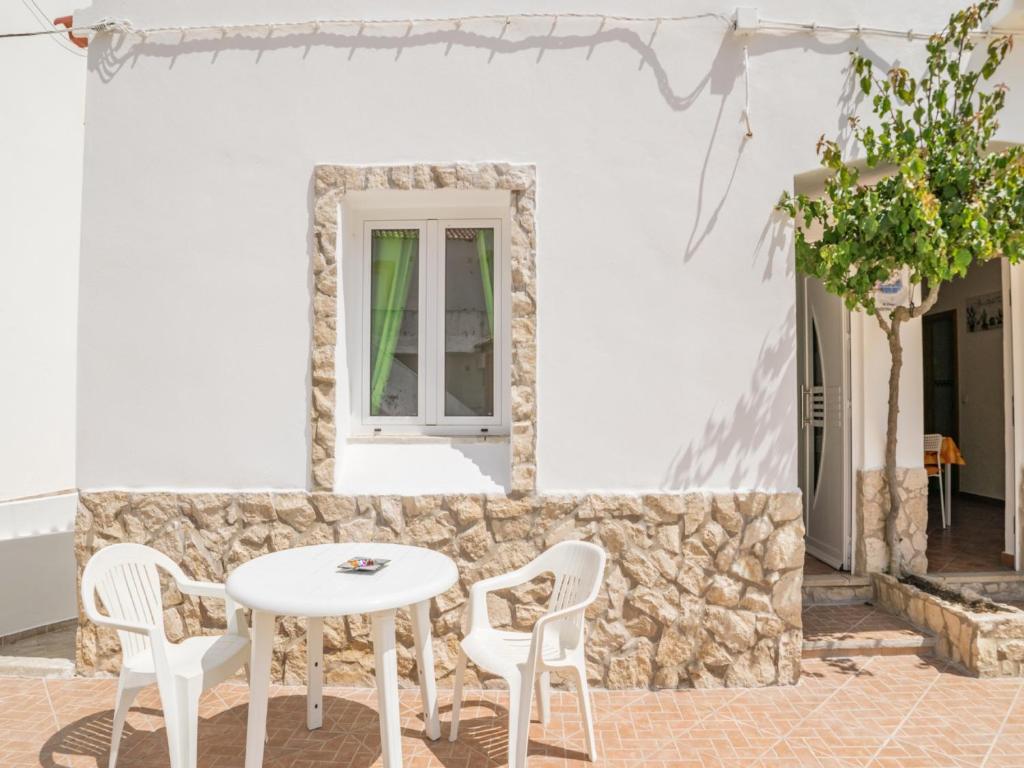 a table and chairs in front of a white building at Akivillas Lagos Zircon in Lagos