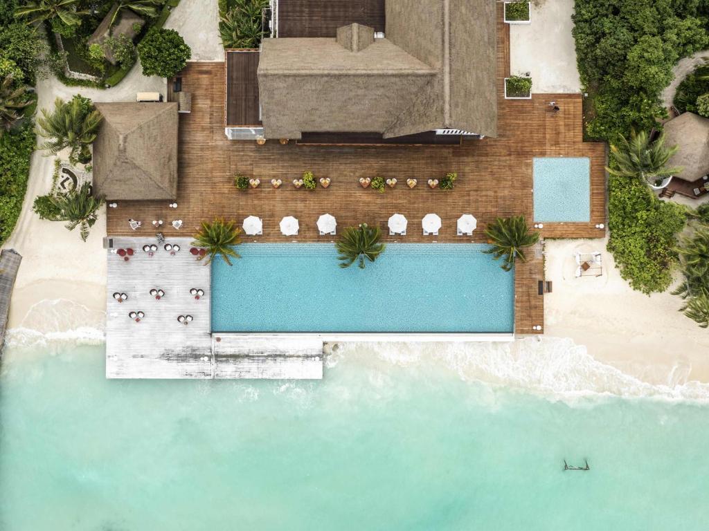 an overhead view of a swimming pool on a beach at Mercure Maldives Kooddoo - Adults-Only Escape - 50 percent off Domestic Transfers in Gaafu Alifu Atoll