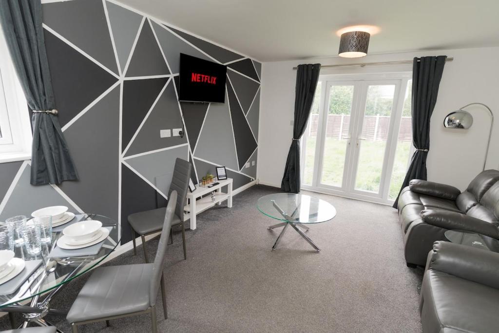 a living room with a couch and a table at Contractors-Relocation-Free Parking-M5 Junction2 in Oldbury