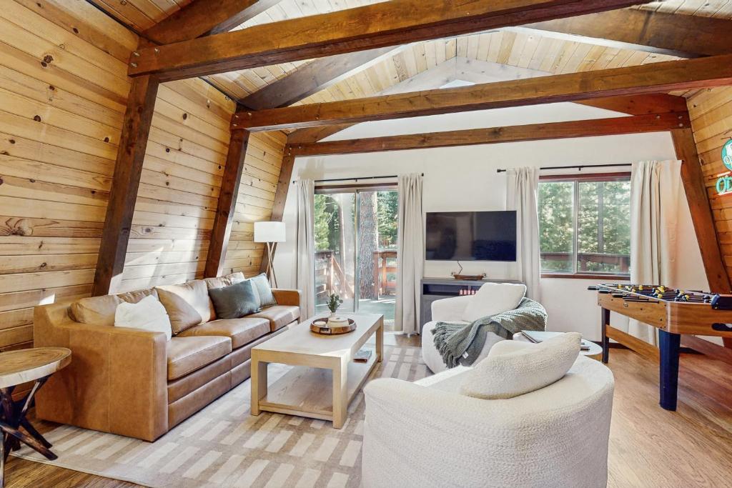 a living room with a couch and a table at Charming Cabin in Bijou