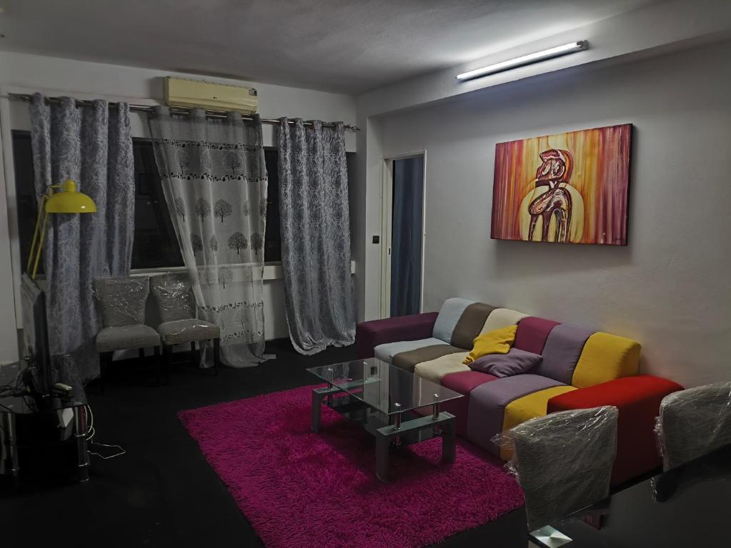 a living room with a couch and a table at Studio chambre salon cuisine in Dakar