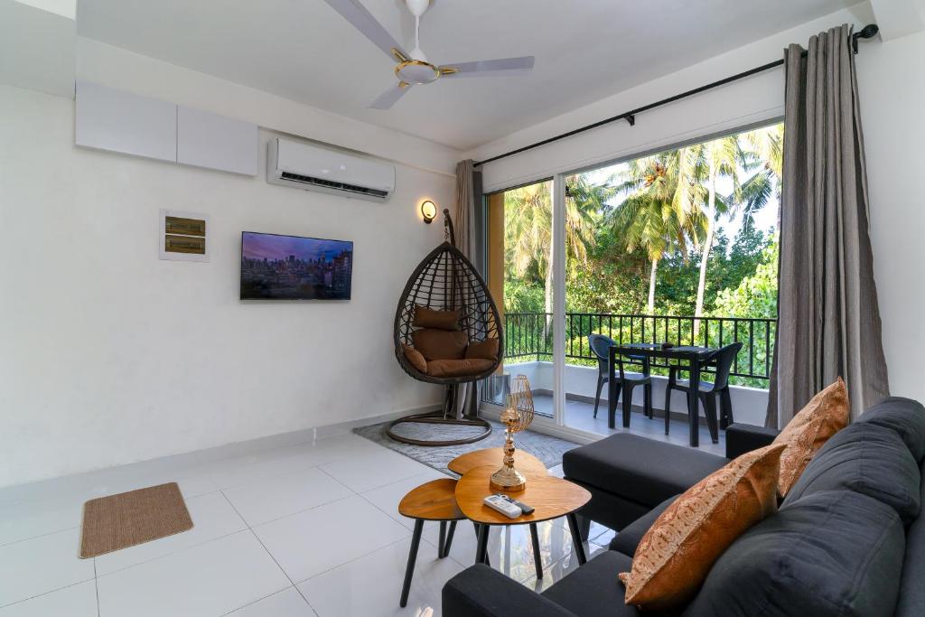 a living room with a couch and a table at La Sky Stay in Ukulhas