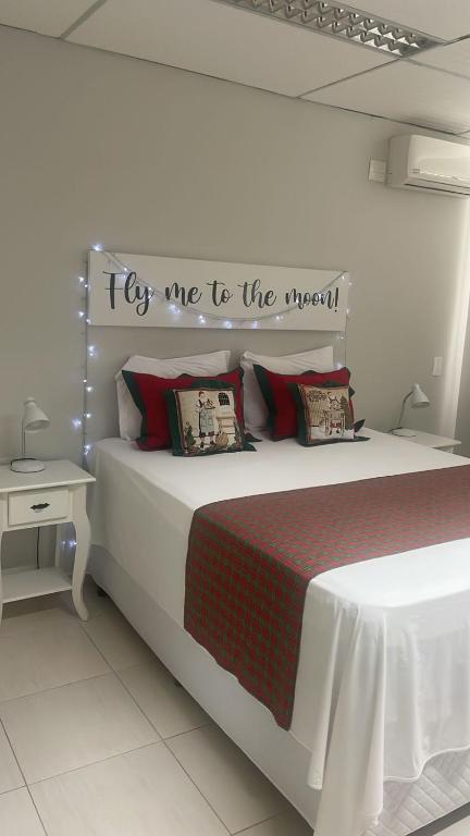 a bedroom with a bed with a sign that says try me to the moon at Fish Inn Hotel in Barra Velha