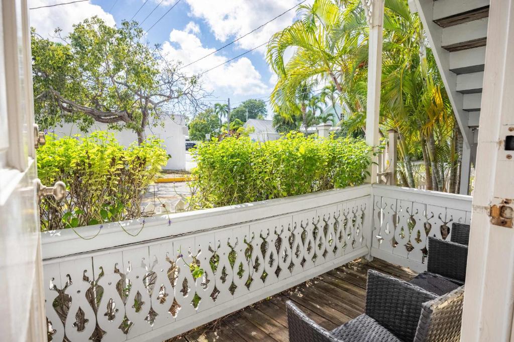 a balcony of a house with chairs and trees at Sea Breeze -Great Location! in Key West