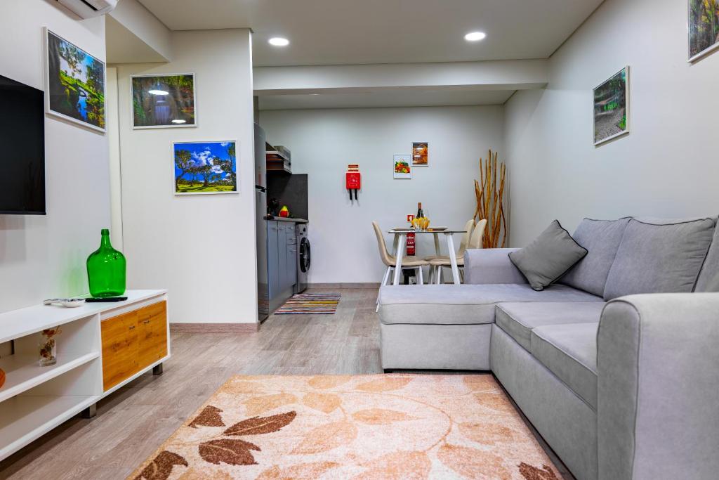a living room with a couch and a table at LaurissilvaLodge in Senhora do Rosário