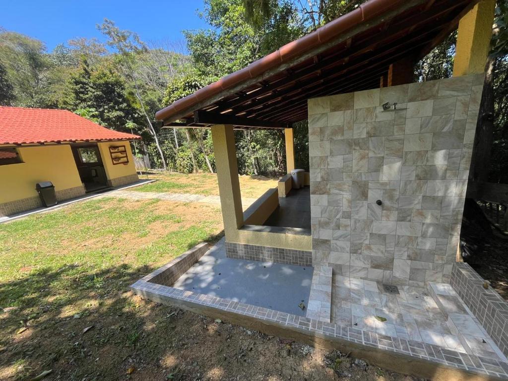an outside view of a house with a patio at Sítio com rio e muito verde! in Rio Bonito