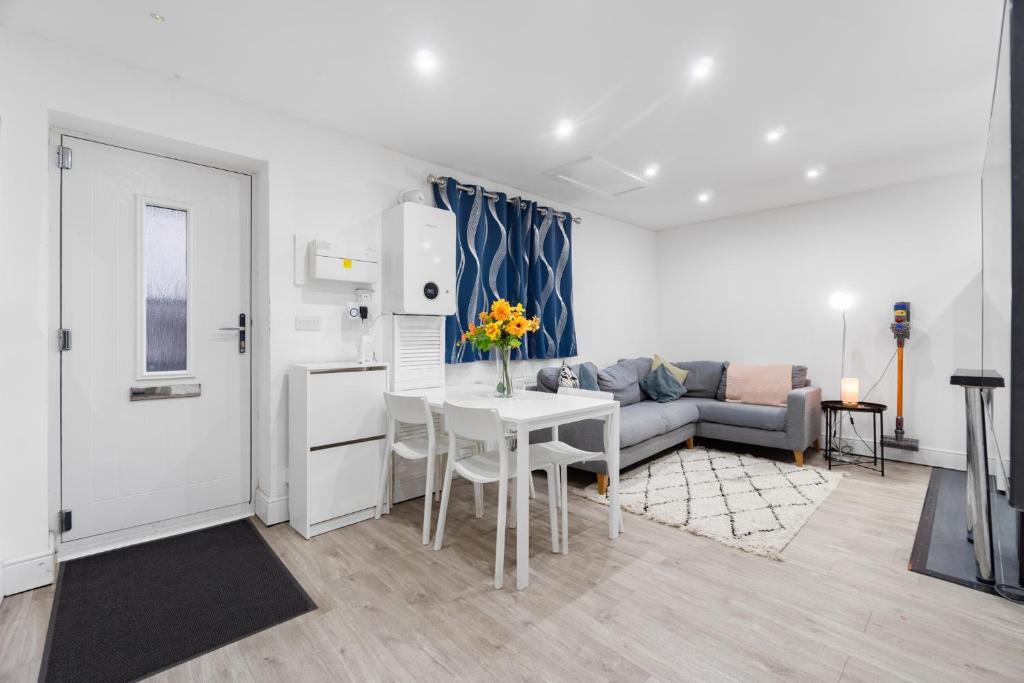 a living room with a couch and a table at 2 Bedroom house,BrownhillRd SE6 in London