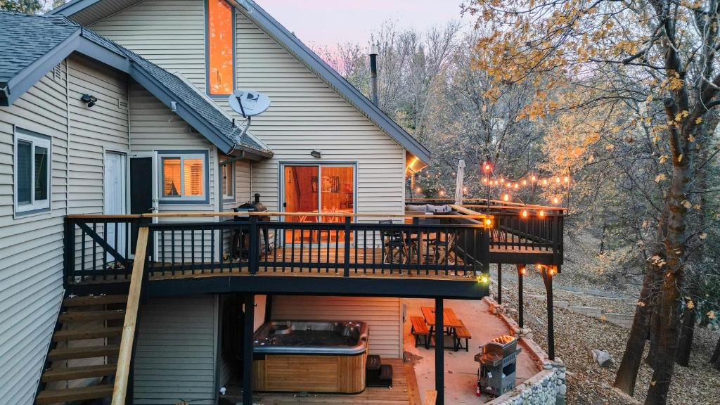 a deck with a hot tub on a house at 5BDR Hot Tub Deck Firepit Mins to Village Lake The Hilltop by AvantStay in North Shore