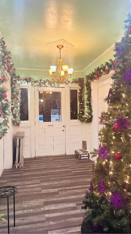a porch with a christmas tree and a white garage at Big Mama's House in Paterson