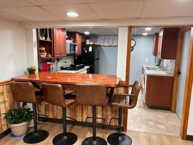 a kitchen with a large wooden table and chairs at Pet Friendly 2BR • King+Queen • Full Kitchen in Adamstown