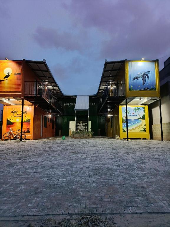 a large building with a brick courtyard in front of it at Studio Borboletas de luz in Bombinhas