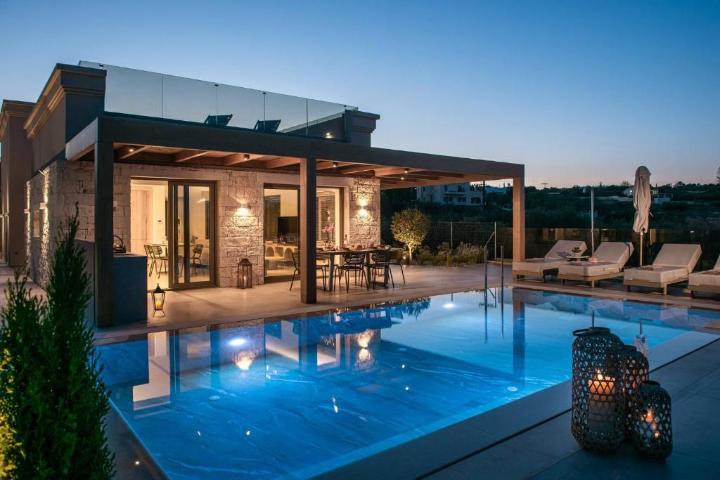 a house with a swimming pool in front of it at Villa Alquimia Aa with private Swimming pool in Hersonissos