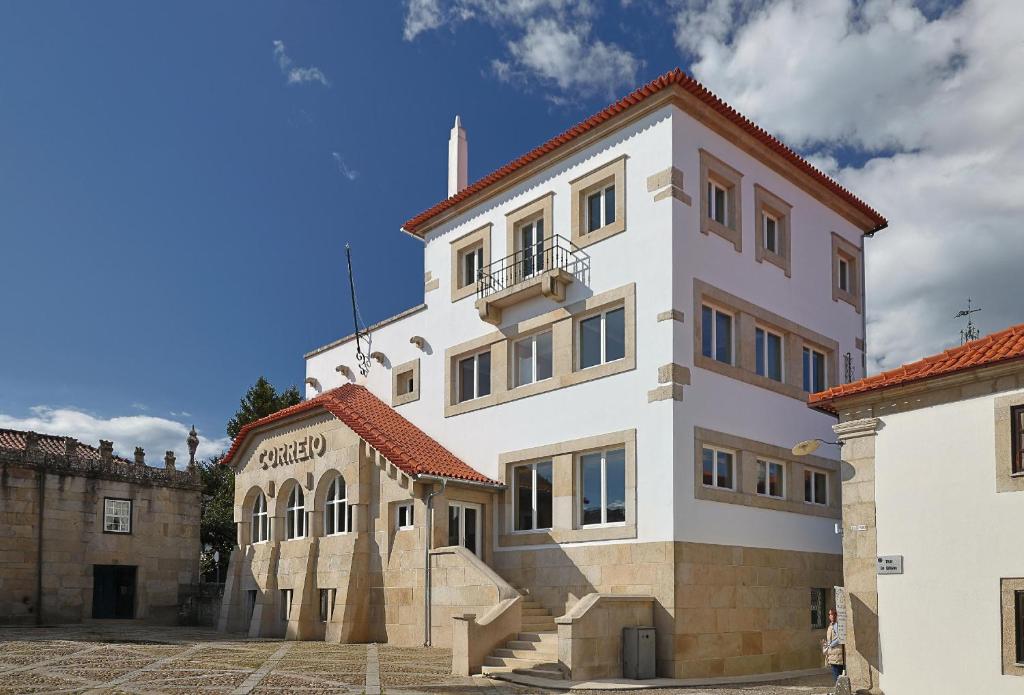 ein großes weißes Gebäude mit einer Treppe davor in der Unterkunft Casa Correio Boutique Hotel in Valença