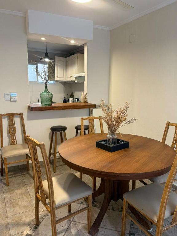 a kitchen and dining room with a wooden table and chairs at Capibara 7 - Alborada in Corrientes