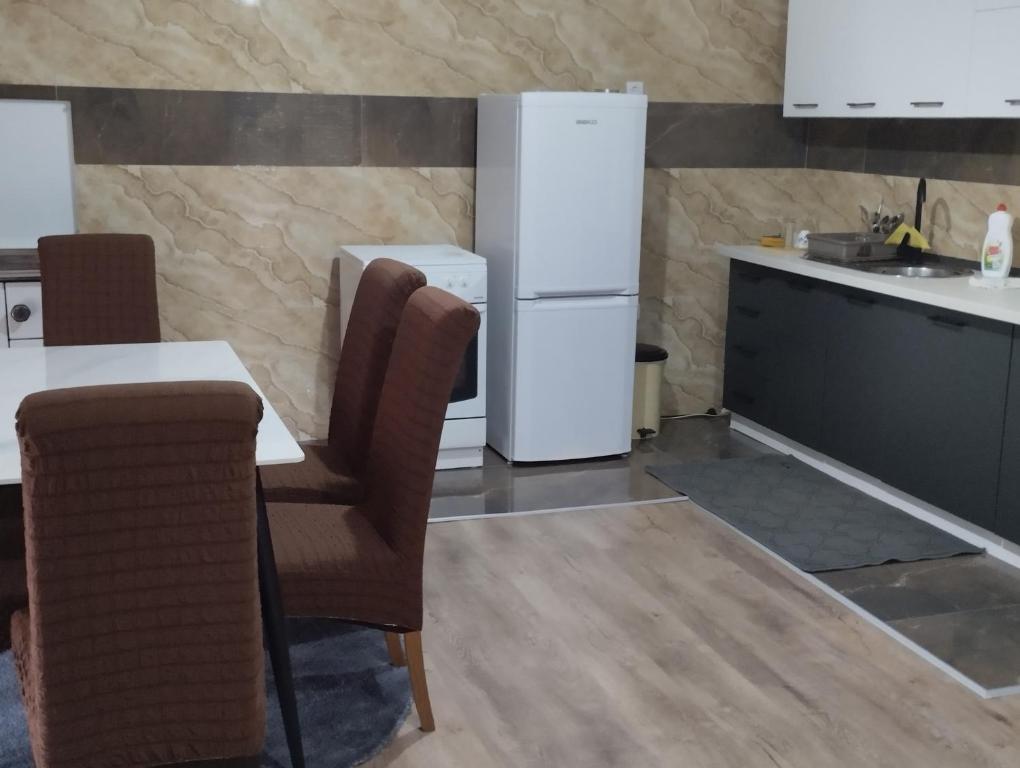 a kitchen with a table and a refrigerator at Apartman Mona Liza Banja Luka in Božići