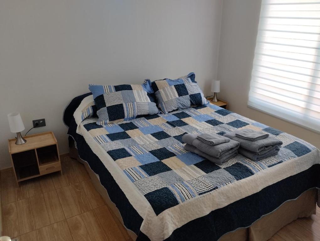 a bedroom with a bed with pillows on it at Cozy cabin for 4 people San Pedro de Atacama in San Pedro de Atacama