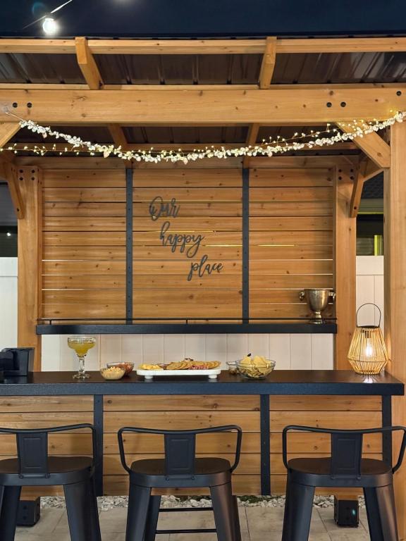 a counter with chairs and a table with food on it at Madeira Beach Family & Pet Friendly Luxury Getaway in Seminole