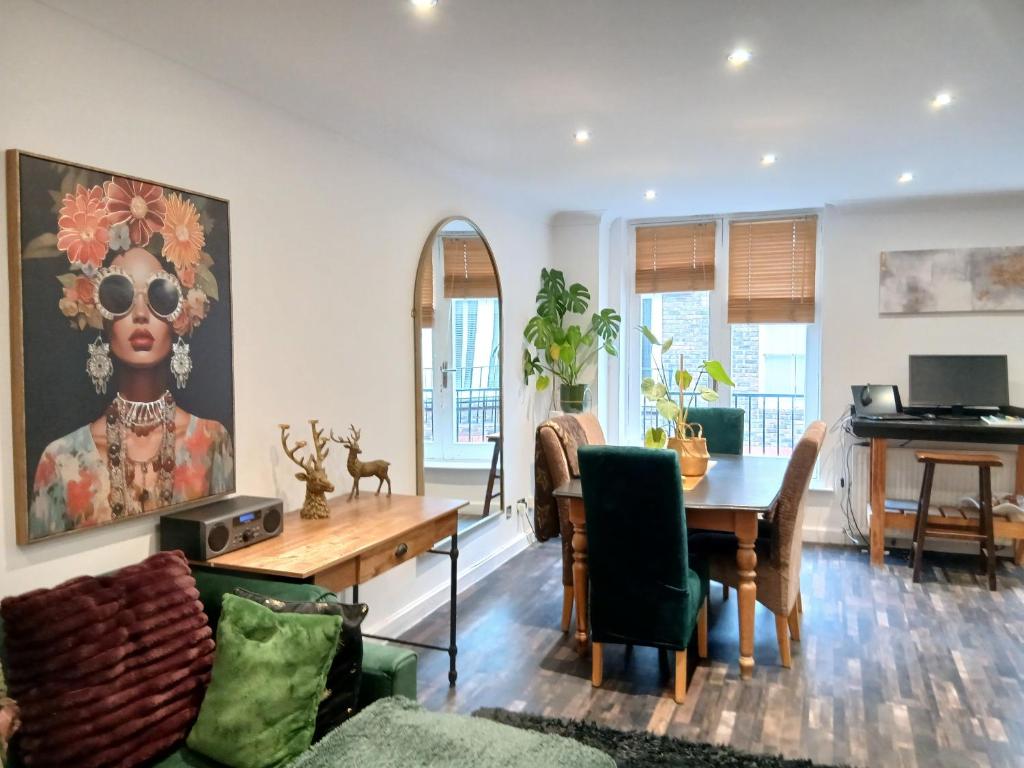 a living room with a table and a piano at Contractors LONG TERM BOOKINGS in London