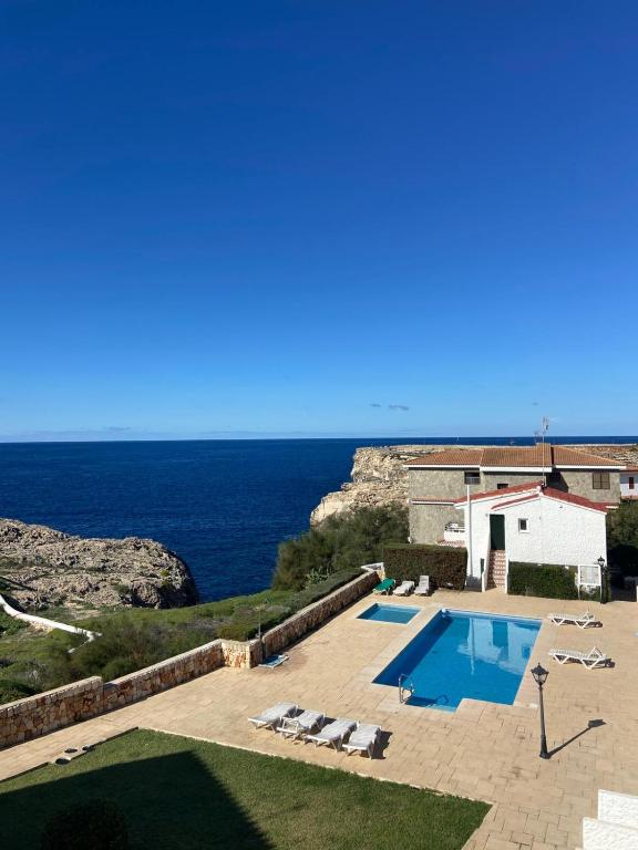 a swimming pool with a view of the ocean at Casa Tesoreta in Cala en Forcat