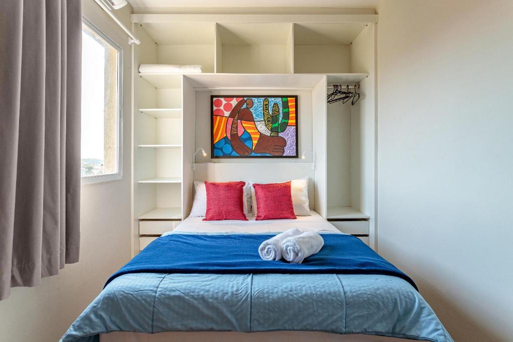 En eller flere senge i et værelse på Residencial Lares do Rosa