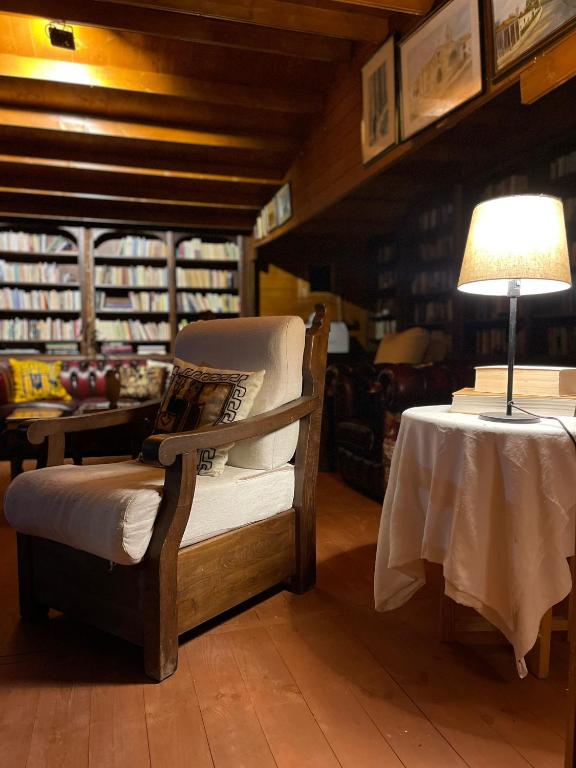 a room with a chair and a table with a lamp at Herdade de Açores in Aldeia Rica