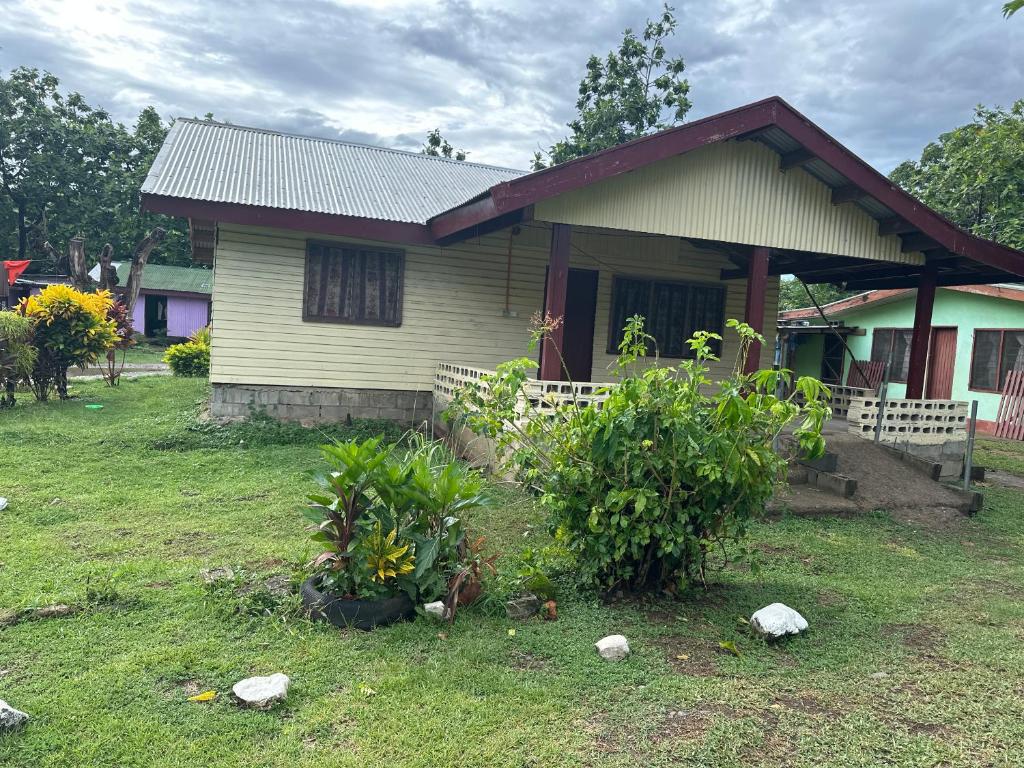 a small house with a grassy yard in front of it at Sujees surf stay, cloudbreak in Nadi