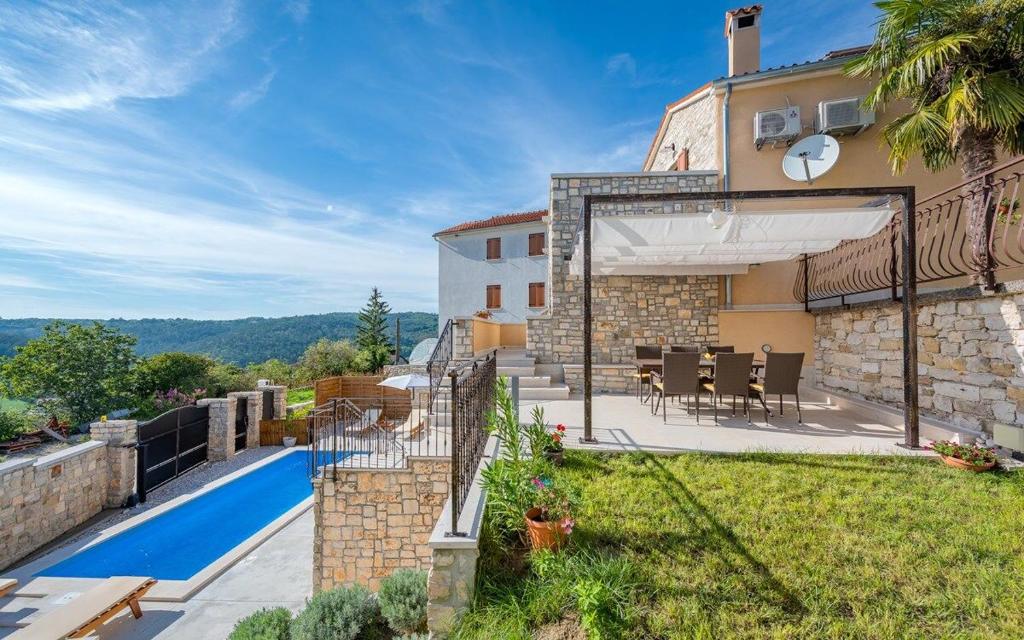 an external view of a house with a swimming pool at Villa Beram in Pazin
