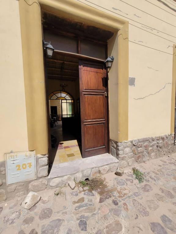 an entrance to a house with a wooden door at Ñawpa Wasi in Humahuaca