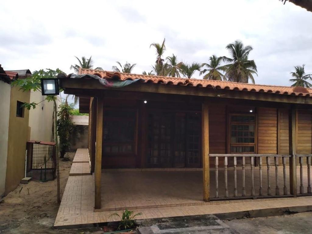 a house with a porch with a fence at Casa familiar para férias in Belas