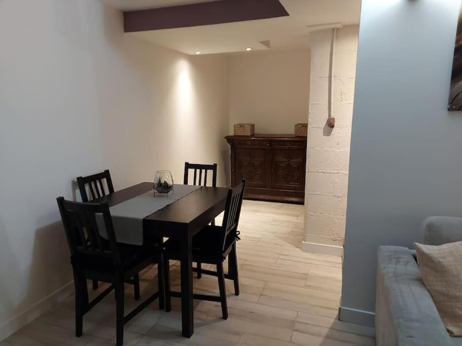 a dining room table and chairs in a living room at Magnifique Studios proche de Paris dans le Yvelines in Ecquevilly