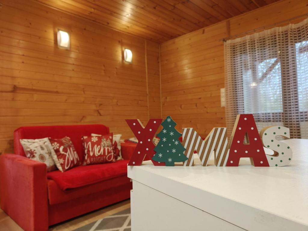 a living room with a red couch and christmas decorations at Nowoczesny Domek Góralski in Kielce