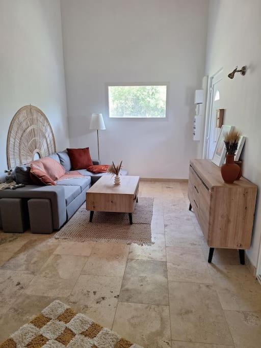 a living room with a couch and a coffee table at Maison type T3 à Ventabren in Ventabren