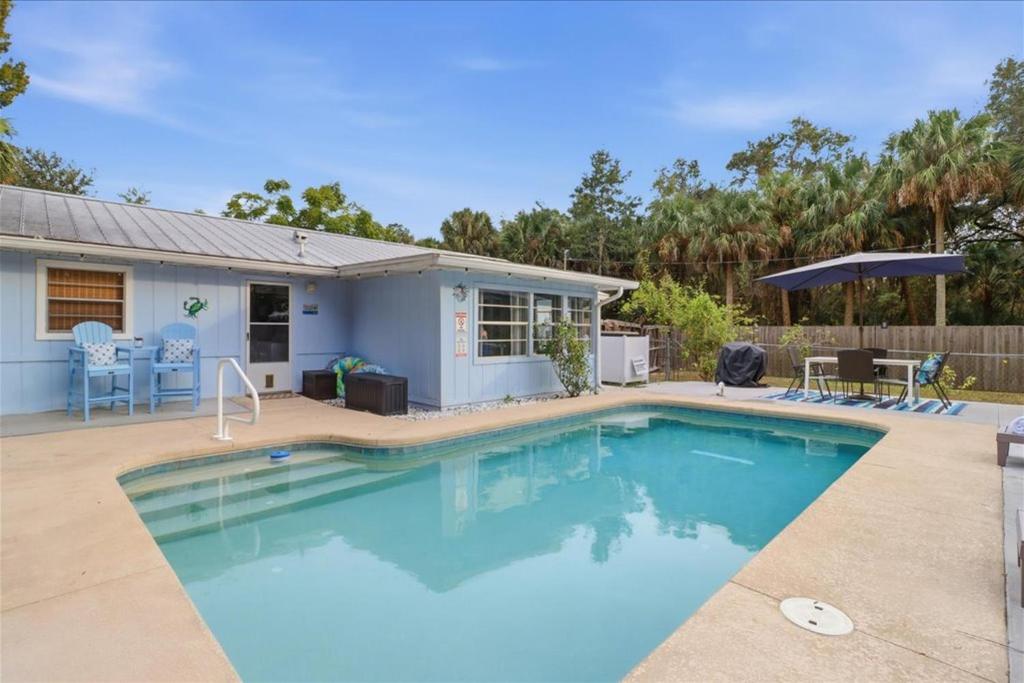 a swimming pool in front of a house at Crystal Blue Haven in Crystal River