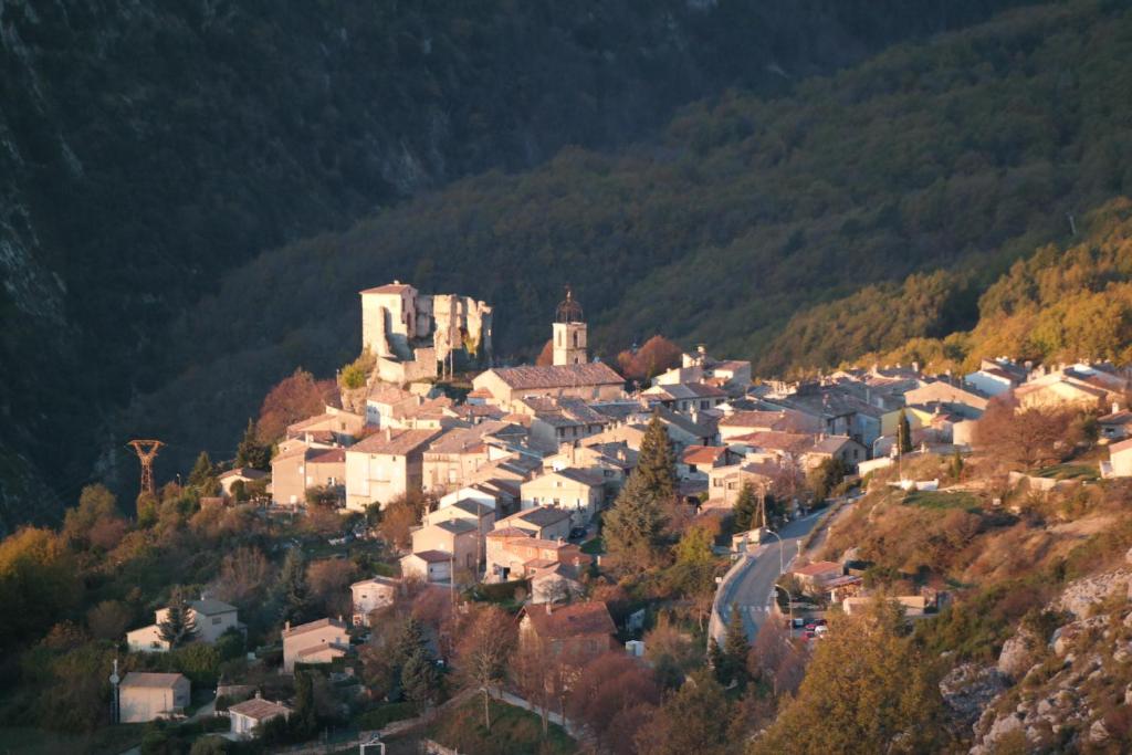 a small town on a hill in the mountains at Au Pied du Château in Gréolières les Neiges