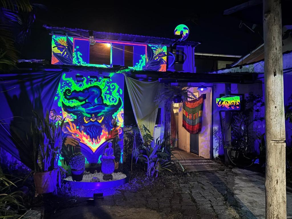 a house decorated in purple and green lights at Casa Lee Hostel in Paraty