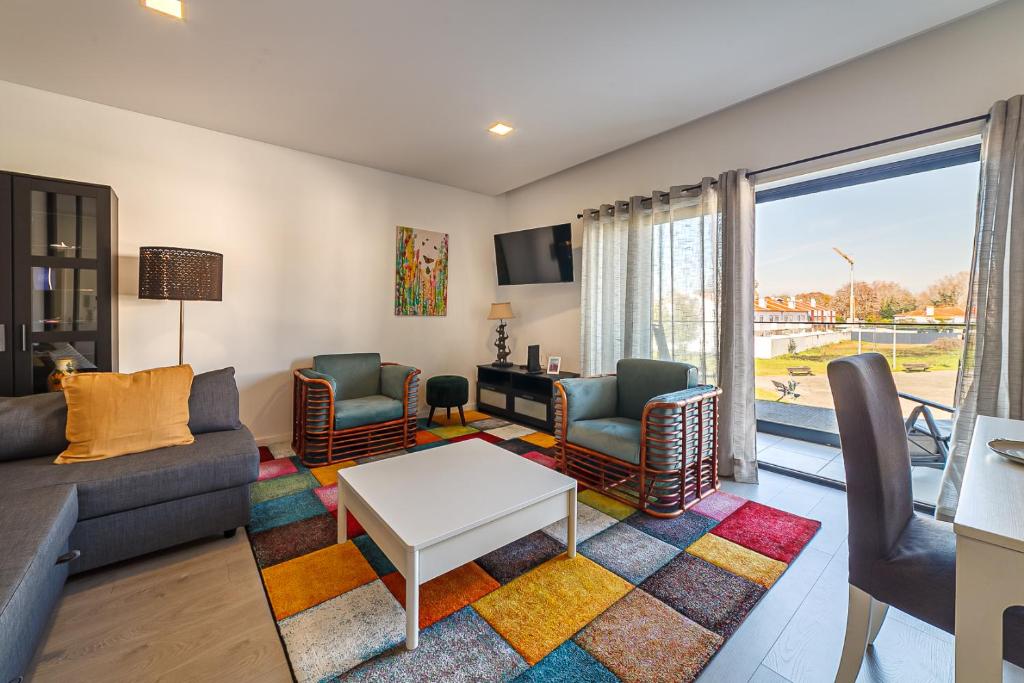 ein Wohnzimmer mit Sofa, Stühlen und einem Tisch in der Unterkunft Modern & Quiet 2BR 2 Baths 4 Balconies & Lift in Ílhavo
