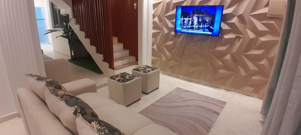 a living room with a couch and a tv at Villa Hostel in Belém