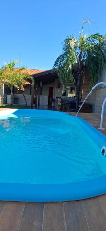 a blue swimming pool with a water fountain at Casa de Bonito in Bonito